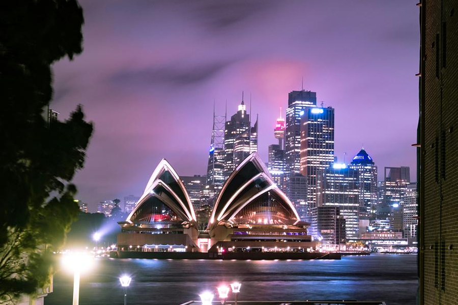 Sydney Opera House and city skyline at night